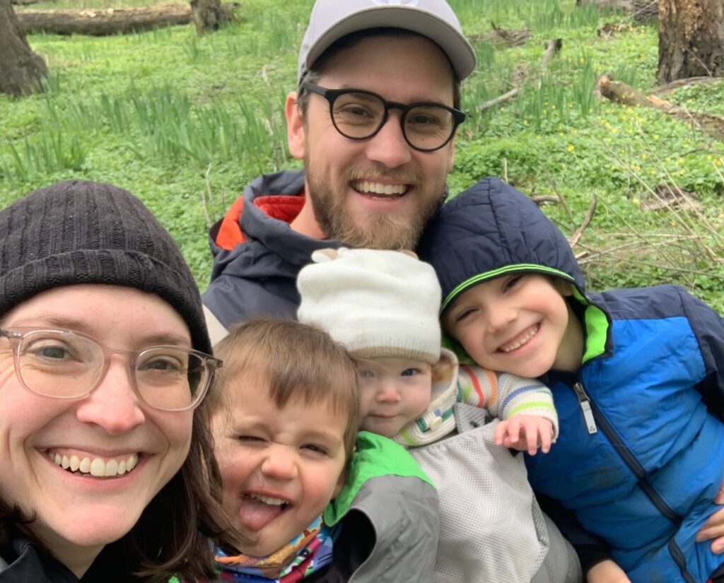 Liann and her family, members of Moveable Feast, smiling together outdoors